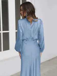 Detailed back view of an elegant blue satin long-sleeved evening dress with a keyhole cut.