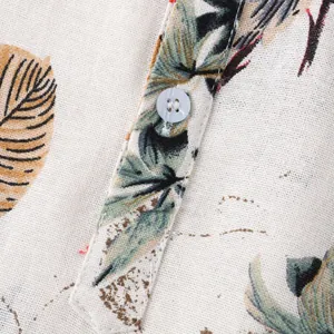 Close-up of Hawaiian print fabric and button detail on men's summer shirt.