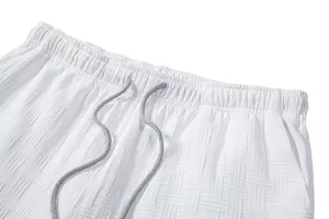 Close-up of white textured fabric and drawstring waistband on men's casual shorts