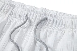 Close-up detail of white seersucker shorts waistband with grey braided drawstring