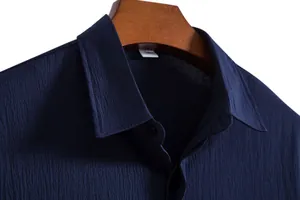 Close-up of men's navy short sleeve shirt collar showing fabric texture