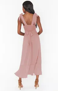 Back view of an elegant dusty rose midi dress with tie straps and smocked bodice.
