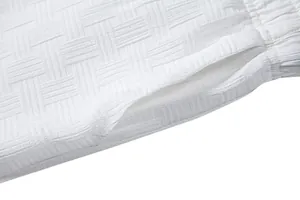 Detailed view of white embossed lattice fabric texture on men's ethnic summer shirt