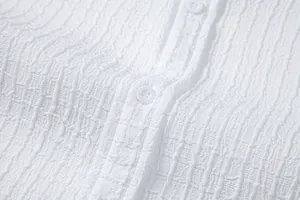 Macro view of white jacquard fabric texture on a casual men's fashion shirt detail