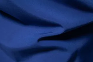 Macro close-up detail showing the fine texture and royal blue weave of the men's shirt fabric.