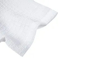 Detailed close-up view of premium white embossed jacquard fabric for men's casual summer shirt