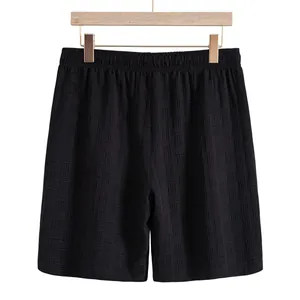 Macro detail view of black textured men's shorts featuring premium elastic waistband design