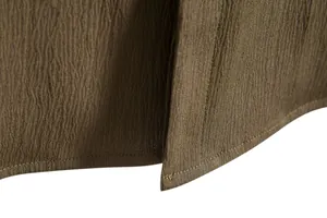 Macro detail of olive brown textured fabric and precision double stitching on shirt hem