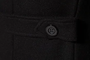 Detailed view of black wool coat fabric texture and classic four-hole button design