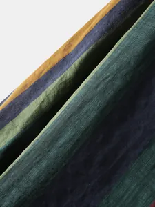 Macro shot of breathable cotton-linen fabric with vintage multicolor stripes texture.