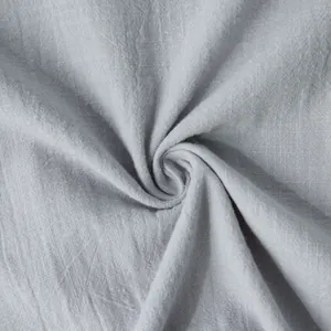 Detailed texture of light gray cotton linen fabric showing natural weave patterns