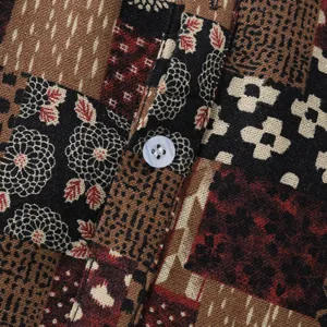 Close-up of vintage patchwork print and white button on men's linen shirt