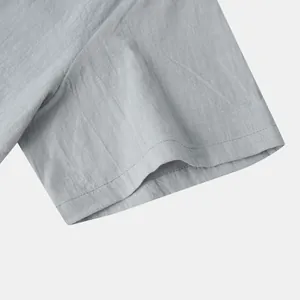 Detailed close-up view of the sleeve cuff on a grey men's cotton linen casual summer shirt