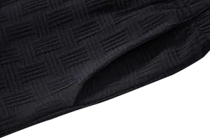 Close-up of black textured fabric and pocket detail of men's ethnic style shirt set.