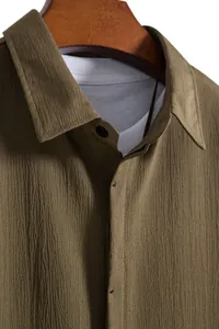 Close-up of olive green men's shirt showing the premium crinkled fabric texture.