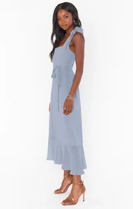 Elegant light blue French-style midi dress with shoulder ties and waist sash