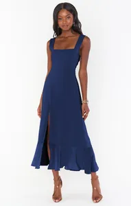 Detail showing elegant navy blue split midi dress with square neck and ruffle hem.