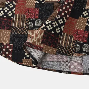 Close-up detail of men's Hawaiian shirt fabric showing retro colorful patchwork print