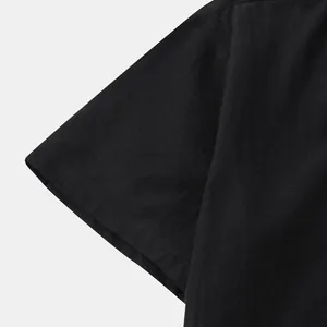 Close-up detail showing the breathable black cotton linen fabric of a men's casual shirt