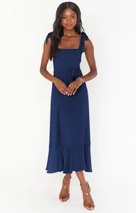 Elegant navy blue sleeveless midi dress featuring chic shoulder tie straps and side slit