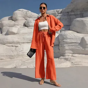 Vibrant orange two-piece casual set featuring long-sleeve shirt and wide-leg trousers