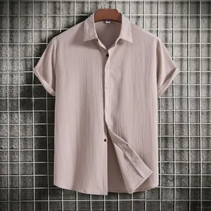 Detail view of khaki men's short sleeve shirt showing textured fabric and buttons