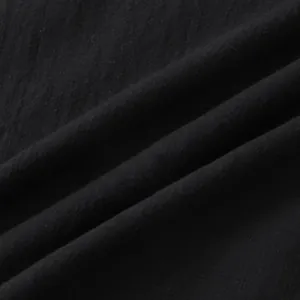 Close-up of black cotton linen fabric texture showing natural fiber details