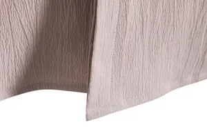 Detailed macro view of crinkled fabric texture and neat stitching on a men's shirt detail