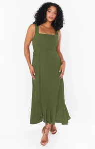 Full-length shot showing the elegant silhouette of an olive green square neck dress.