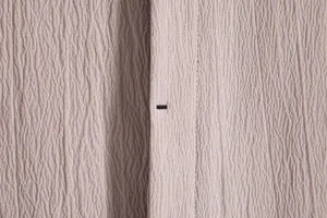 Macro view of textured breathable fabric detail on a minimalist men's short sleeve shirt