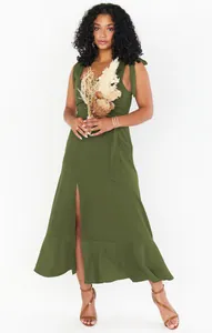 Elegant olive green tie-strap midi dress with a slit and ruffled hem detail.