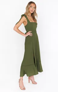 Detailed view of an elegant olive green split midi dress with shoulder bows.