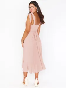Elegant detail of pink French slit dress with bow-tie straps and ruffled hem design