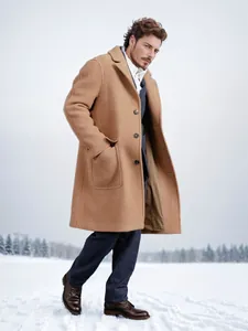 Side view of a men's classic camel long wool overcoat in a snowy winter setting