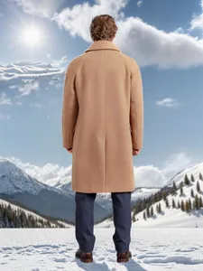 Back view of a classic tan long wool coat for men in a winter snowy mountain setting