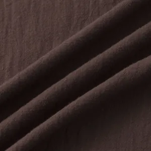 Macro detail of dark brown cotton-linen fabric texture with natural weave and folds