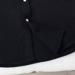 Macro view of white buttons and breathable textured fabric on a navy men's button-up shirt