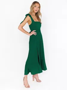 Elegant dark green French style midi dress with tie shoulders and a chic side slit detail