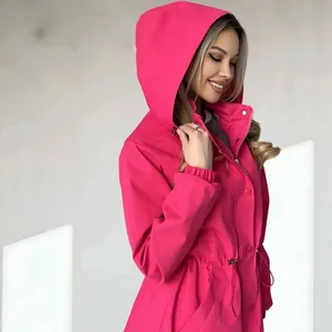 Side view detail of a vibrant pink hooded windbreaker with an adjustable drawstring waist.