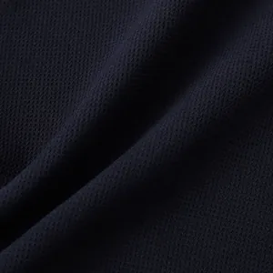 Macro view of breathable dark navy mesh fabric texture for men's casual summer shirt