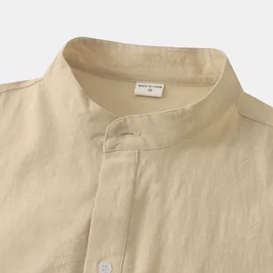 Close-up of men's beige cotton linen stand collar shirt with textured fabric detail