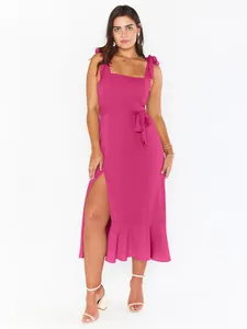 Elegant fuchsia midi dress with tie shoulder straps and a high side slit on model