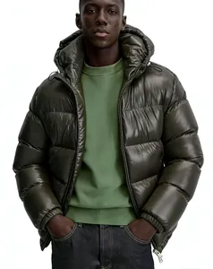 Detailed view of a stylish olive green puffer jacket worn by a male model in studio setting