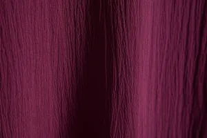 Macro view of dark burgundy textured fabric for men's summer short sleeve shirt