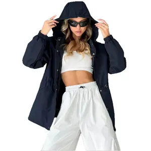 Women's navy blue waterproof windbreaker jacket with hood and white cargo pants