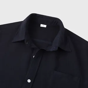 Close-up of textured navy blue men's casual short-sleeve shirt with collar detail