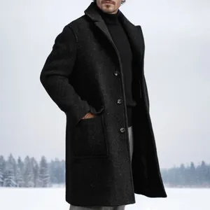Long charcoal single-breasted men's wool coat for winter fashion in snowy landscape