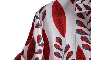 Detail of the shoulder and collar of a men's shirt with red leaf print fabric texture