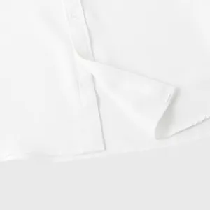Close-up detail of white waffle knit texture on summer casual short sleeve men's shirt.