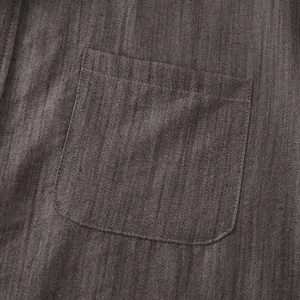 Detailansicht der Brusttasche eines dunkelgrauen Kurzarm-Leinenhemdes für Herren.